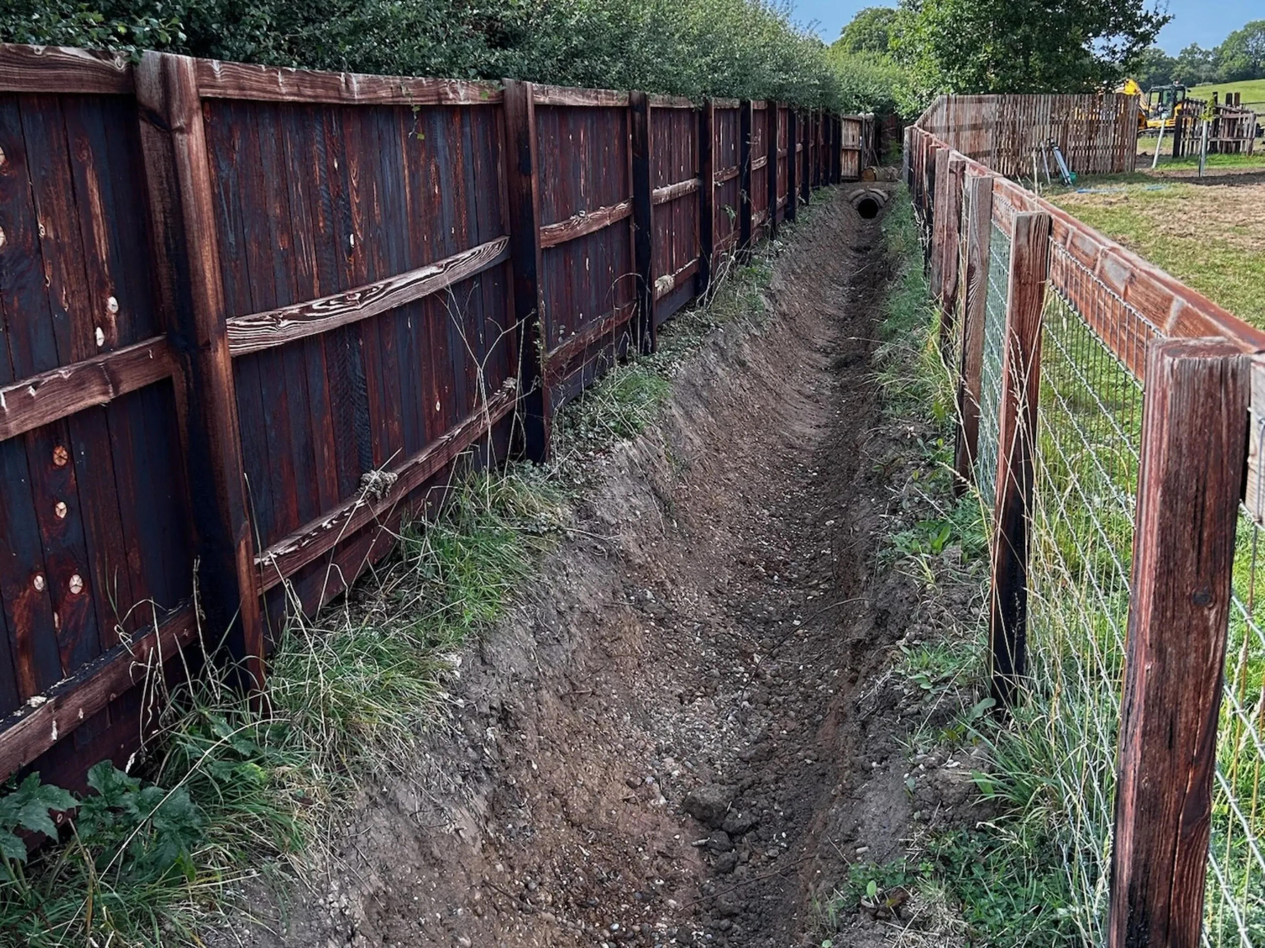 An open ditch between two fences